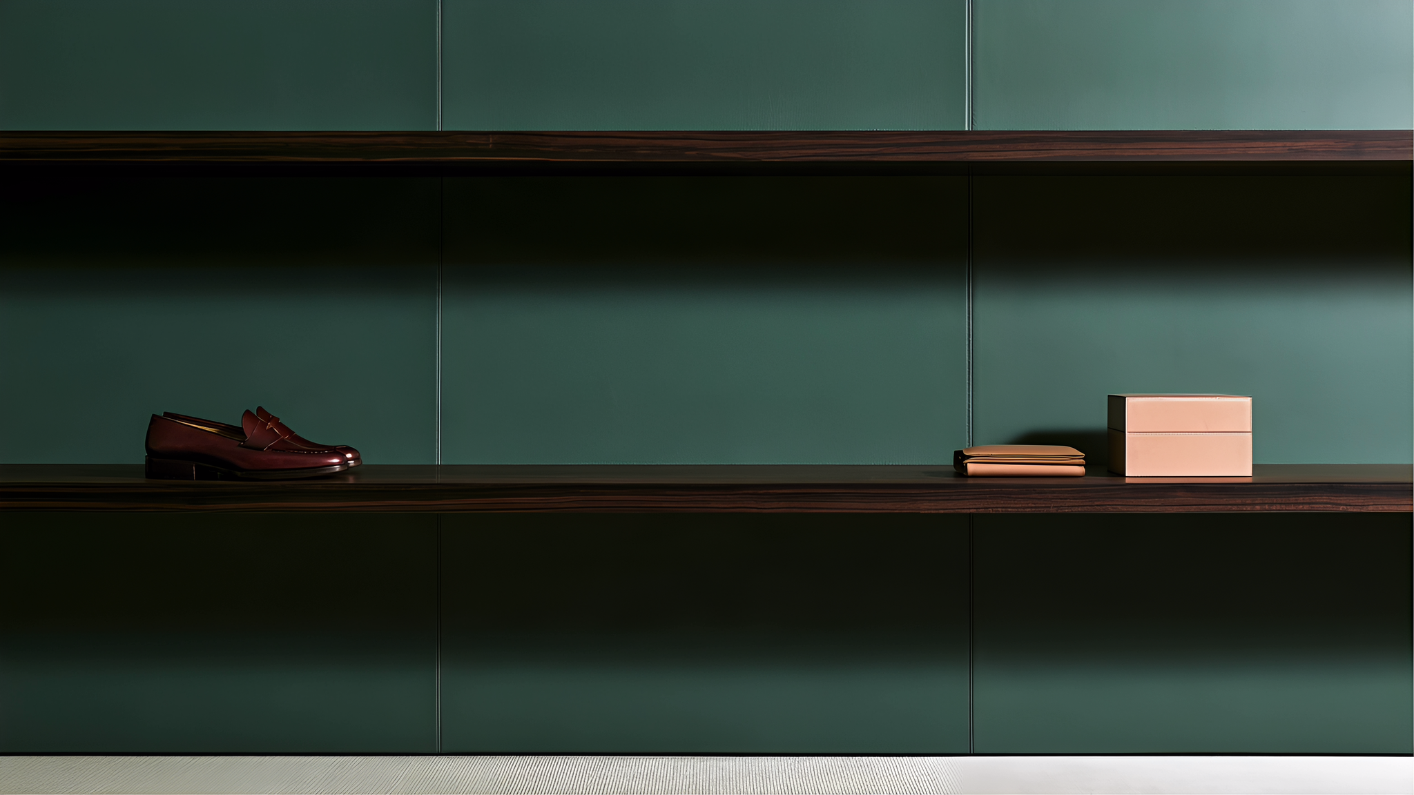 Burgundy leather shoes, a tan wallet and a pale box in a forest-green object archive